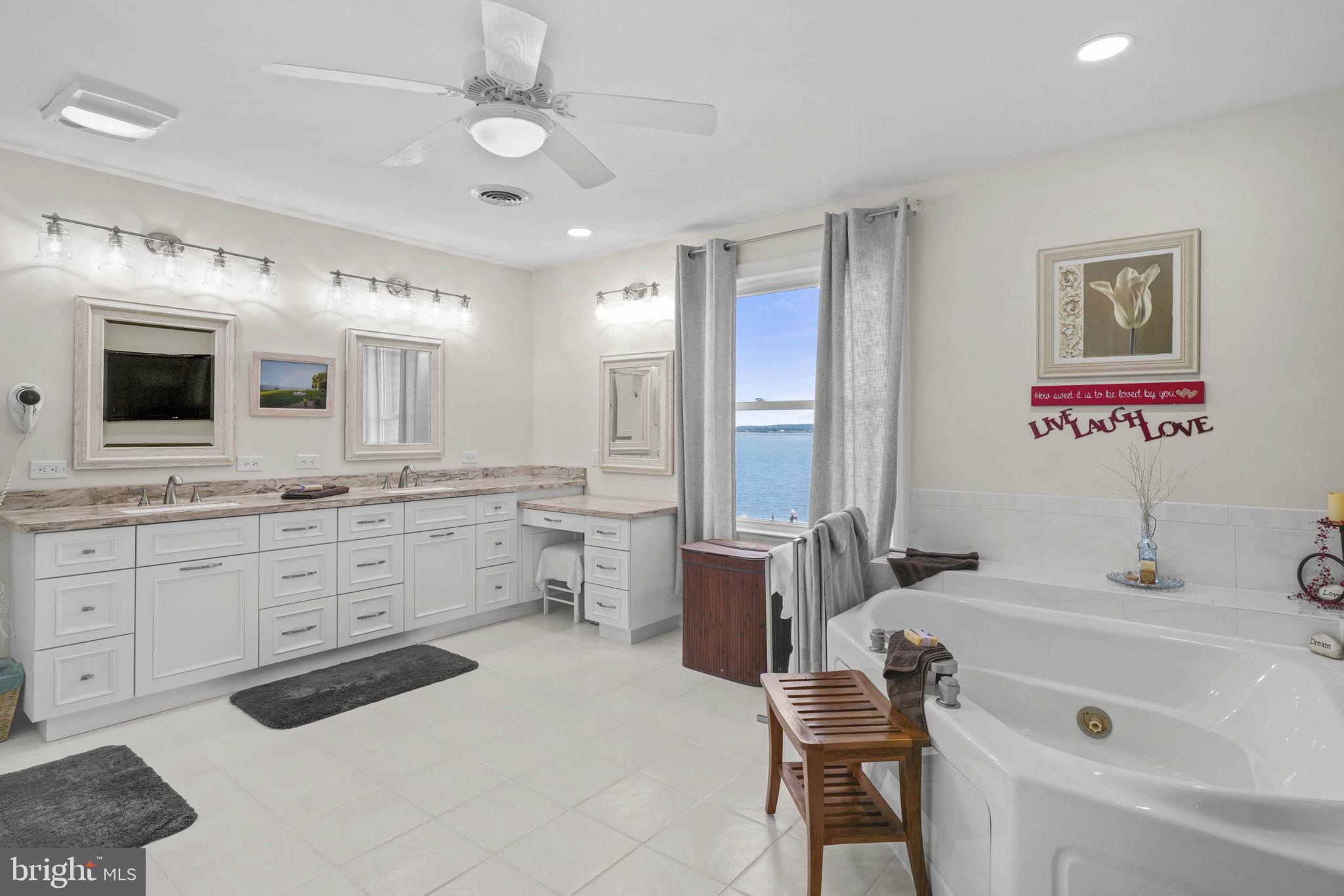 17432 Rock Point Road Newburg, MD 20664 - Photo 30 of 55 a bathroom with a tub sink and mirror