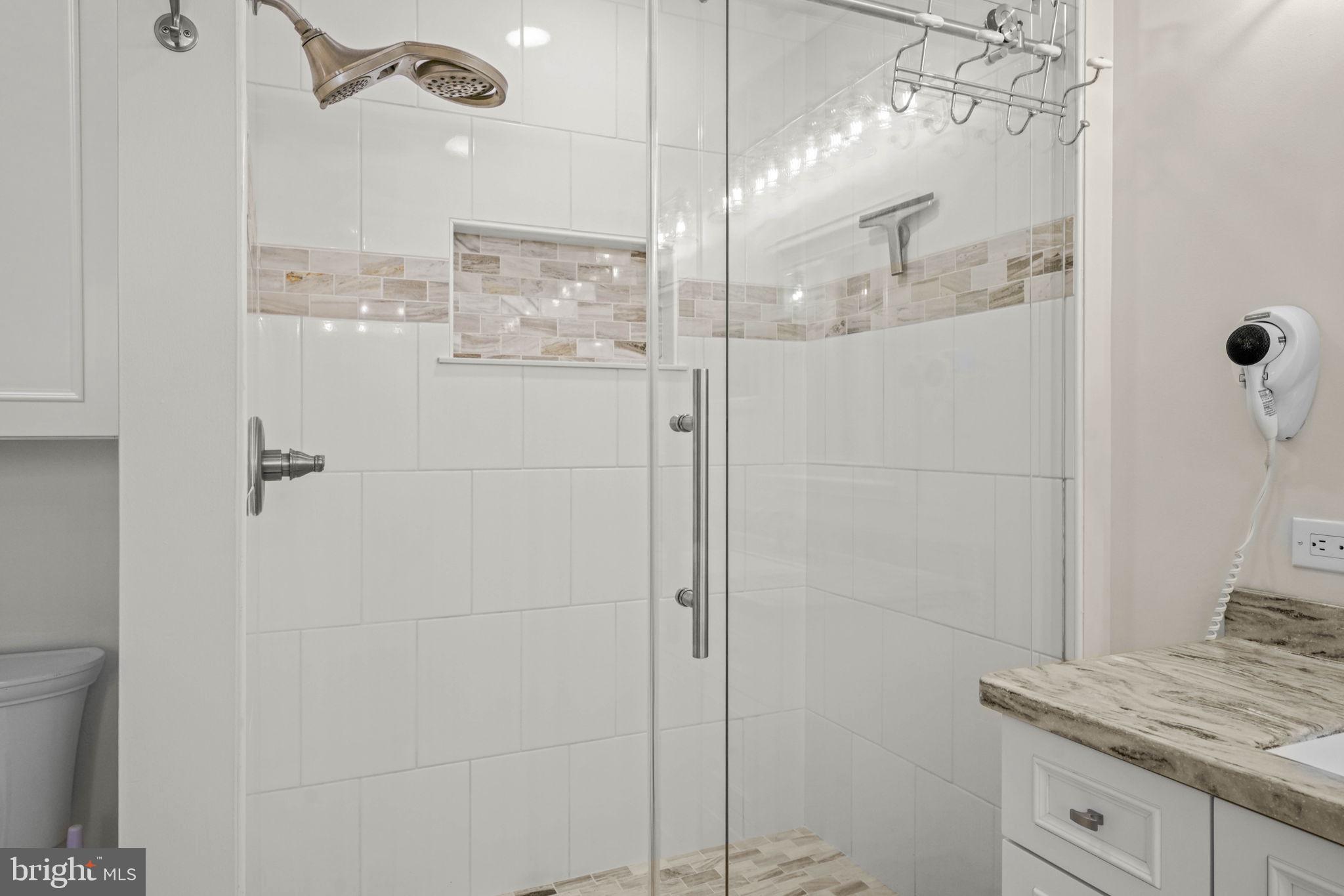 17432 Rock Point Road Newburg, MD 20664 - Photo 32 of 55 a bathroom with a granite countertop shower sink and mirror