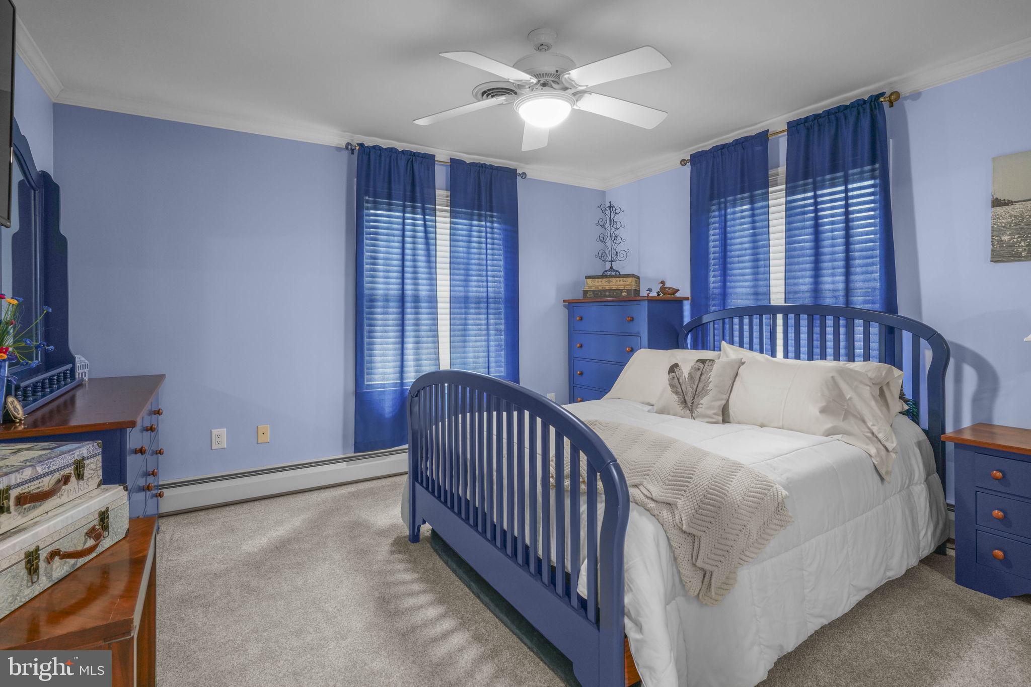 17432 Rock Point Road Newburg, MD 20664 - Photo 34 of 55 a bedroom with a bed and a chandelier