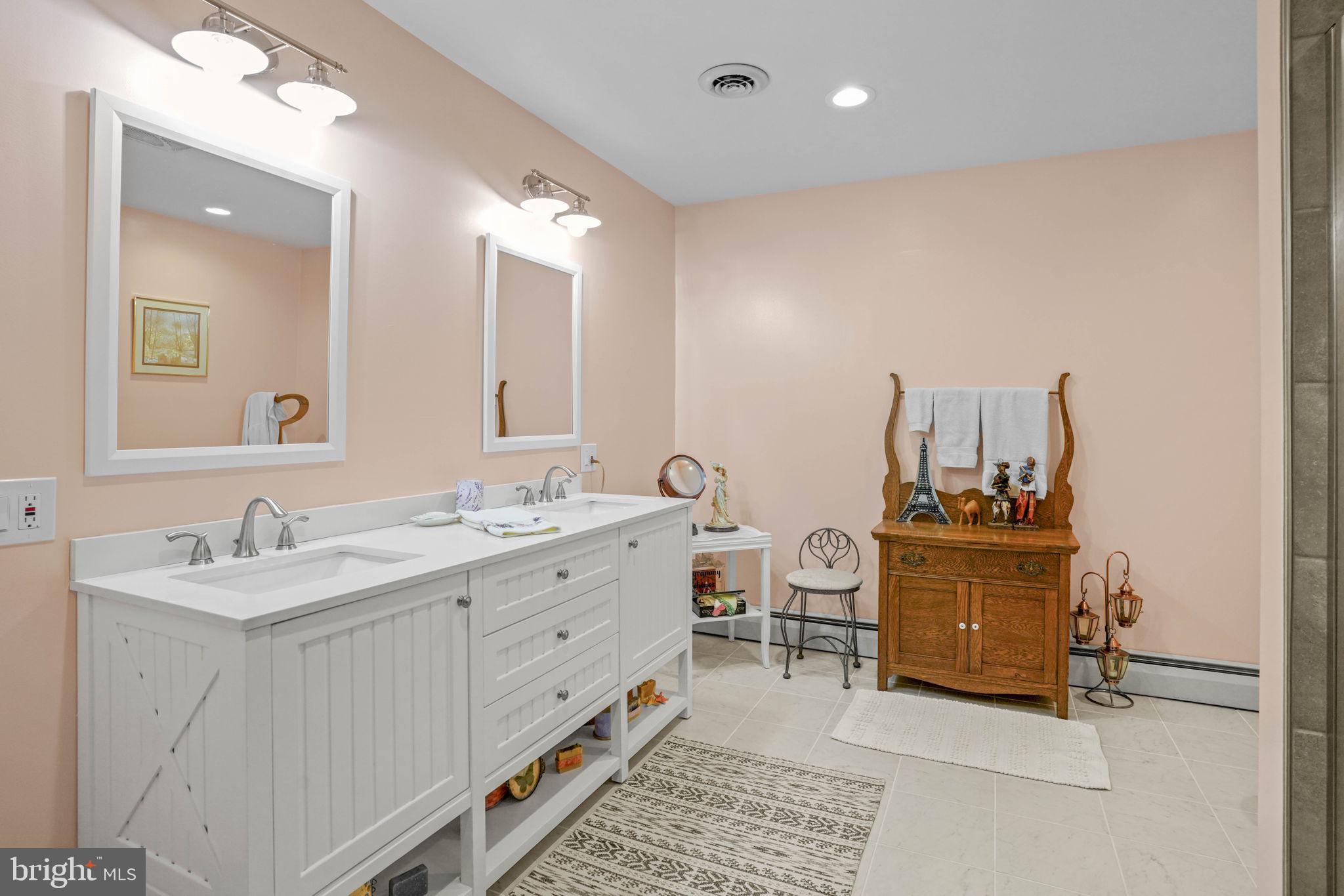 17432 Rock Point Road Newburg, MD 20664 - Photo 36 of 55 a spacious bathroom with a double vanity sink and a mirror