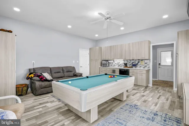 a living room with a table chairs and a window