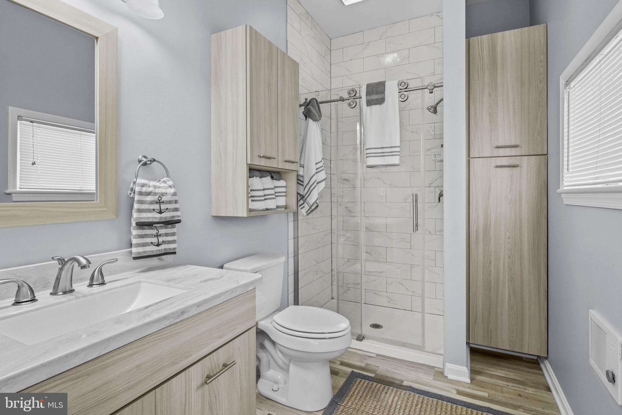 17432 Rock Point Road Newburg, MD 20664 - Photo 40 of 55 a bathroom with a granite countertop sink toilet and shower