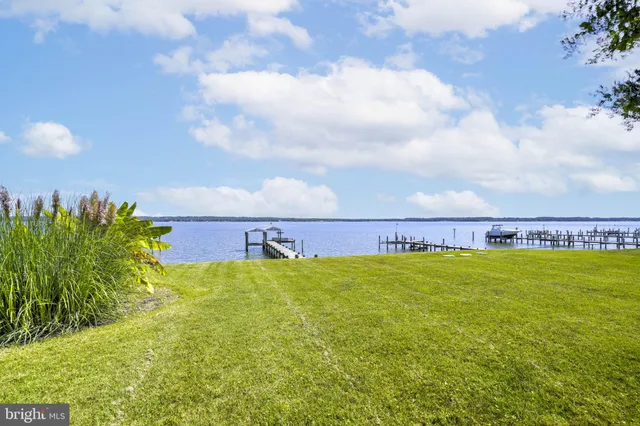 a view of a patio with table and chairs under an umbrella