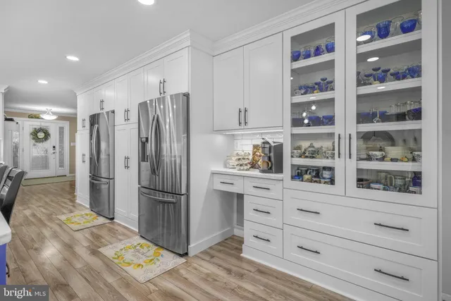 a kitchen with kitchen island granite countertop a sink cabinets and stainless steel appliances