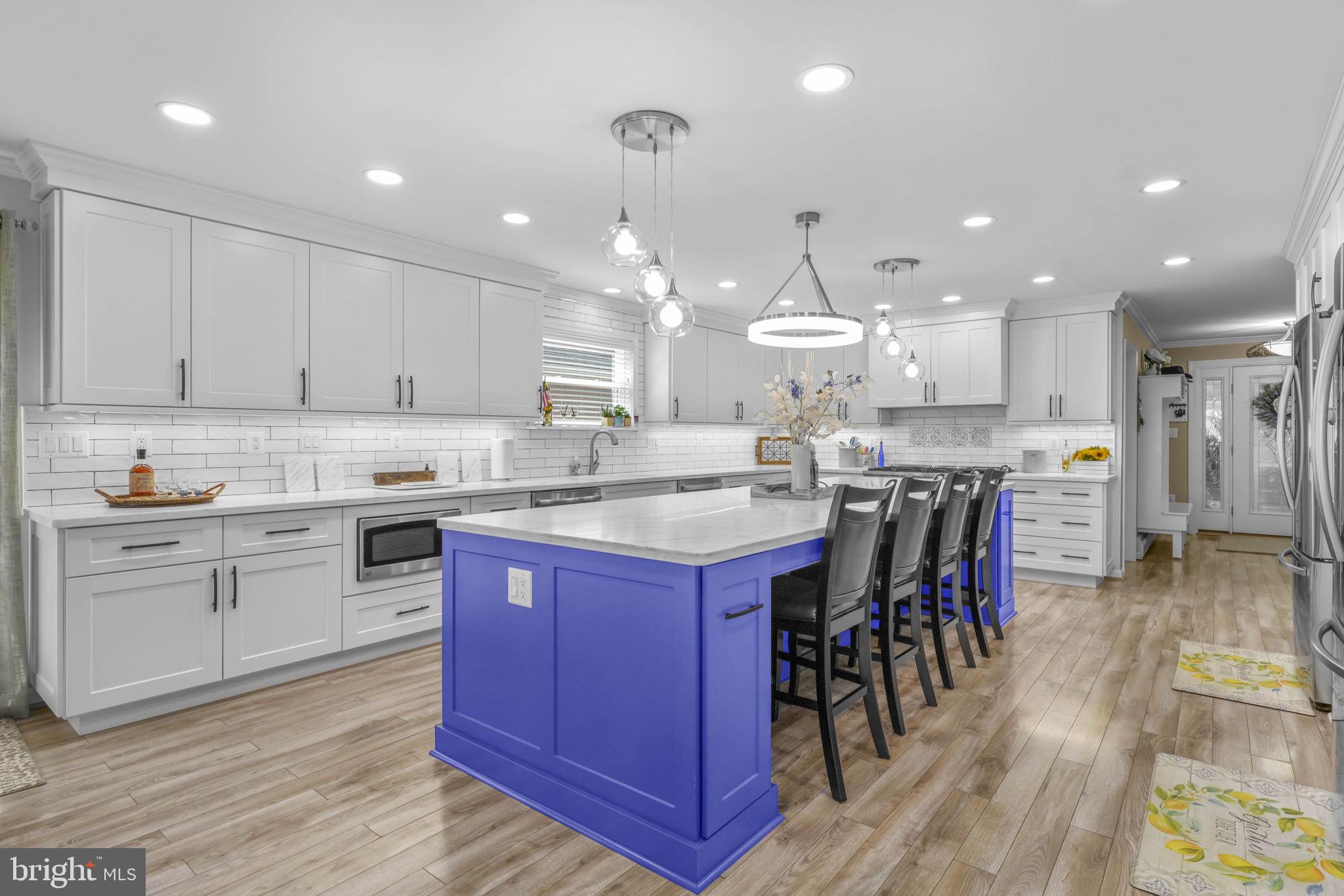17432 Rock Point Road Newburg, MD 20664 - Photo 9 of 55 a kitchen with stainless steel appliances kitchen island granite countertop a table chairs sink and cabinets