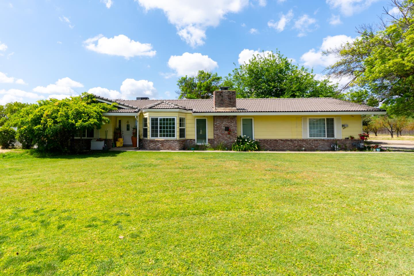 a front view of a house with swimming pool and porch
