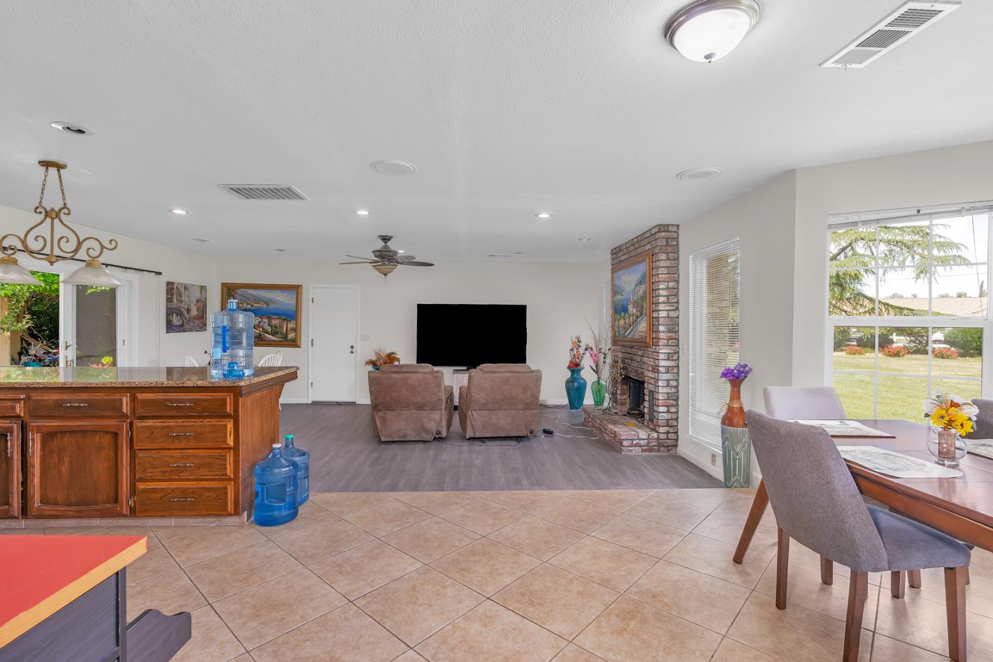 2965 Dunn Road Merced, CA 95340 - Photo 29 of 68 a living room with furniture a flat screen tv and kitchen view