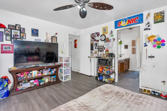 a kitchen with stainless steel appliances kitchen island granite countertop a refrigerator and a wooden cabinets