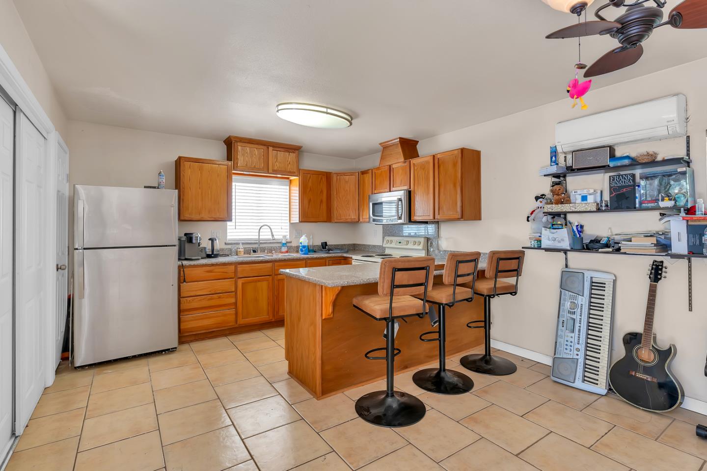 2965 Dunn Road Merced, CA 95340 - Photo 44 of 68 a kitchen with stainless steel appliances kitchen island granite countertop a refrigerator and a wooden cabinets