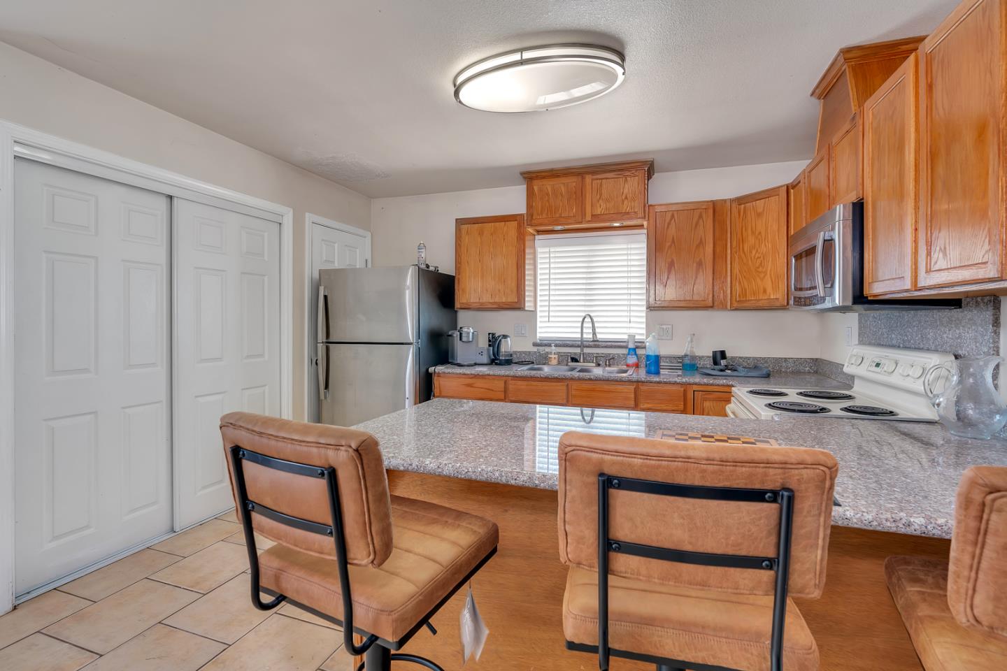 2965 Dunn Road Merced, CA 95340 - Photo 46 of 68 a kitchen with a refrigerator a stove a sink and a cabinets