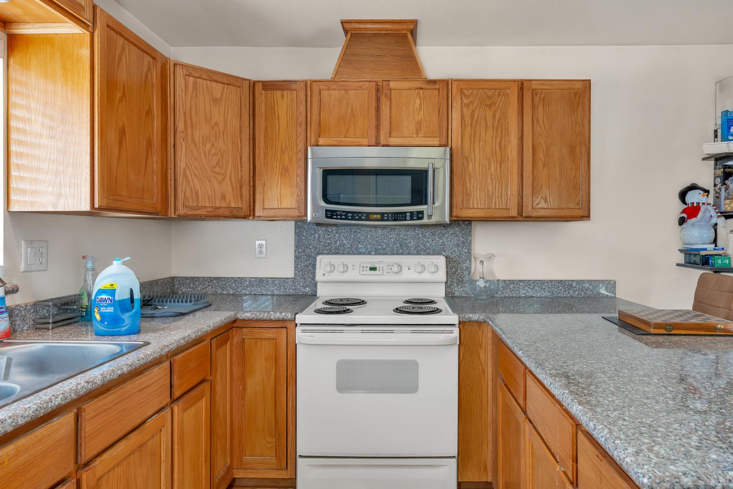 2965 Dunn Road Merced, CA 95340 - Photo 47 of 68 a kitchen with granite countertop a stove top oven microwave and cabinets