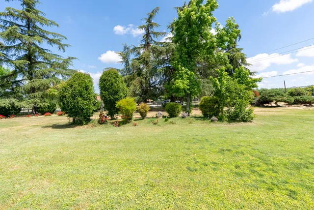 a backyard of a house with yard table and chairs