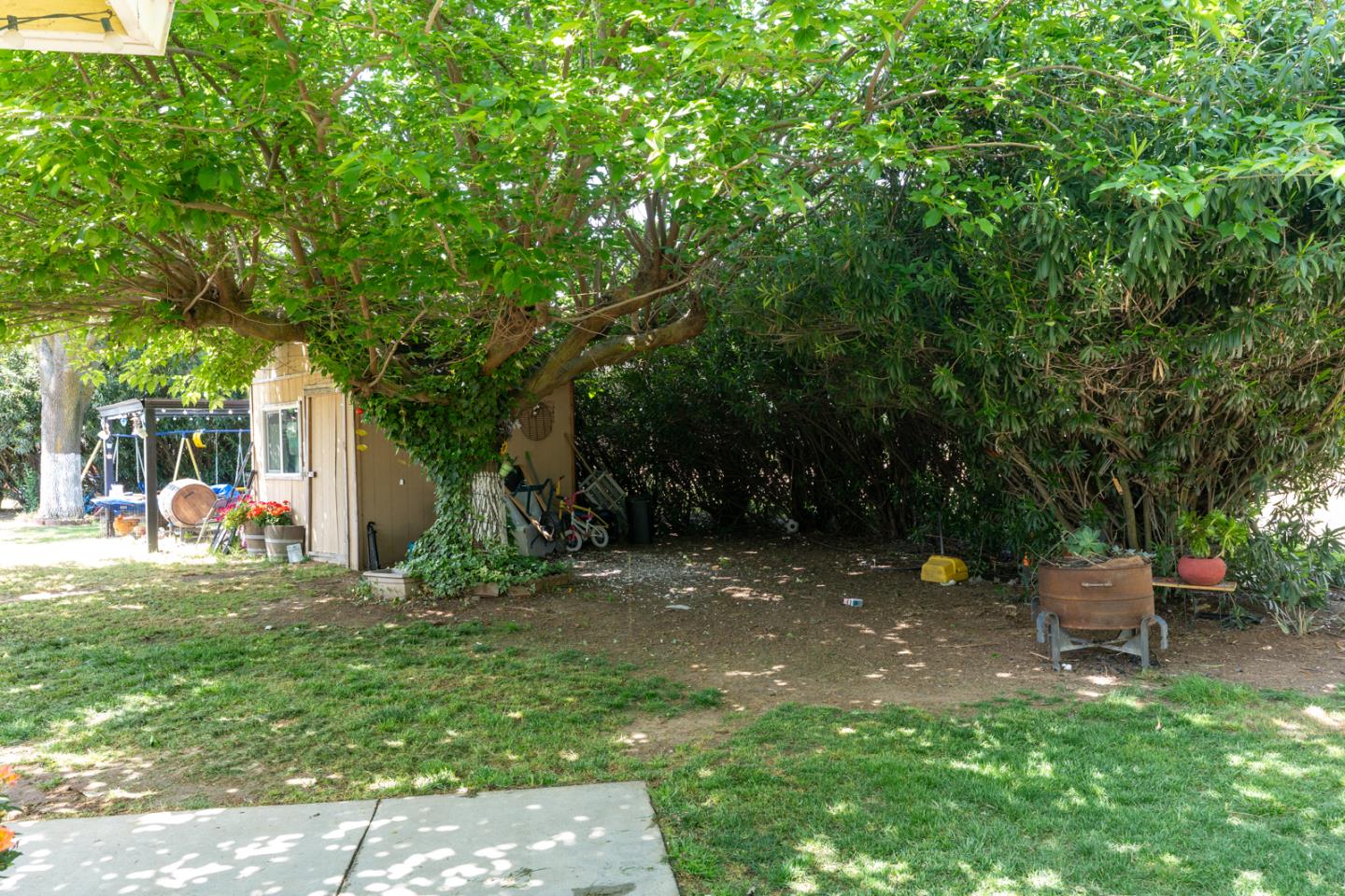 2965 Dunn Road Merced, CA 95340 - Photo 8 of 68 a view of a backyard with table and chairs and potted plants and large tree