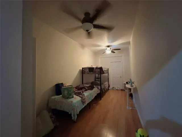 a bed room with furniture and a ceiling fan