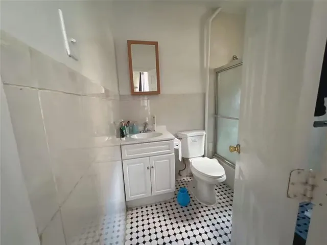 a bathroom with a sink a toilet and a mirror