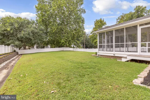 an aerial view of residential houses with outdoor space and river