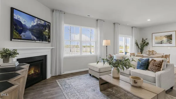 a living room with furniture a fireplace and a painting on the wall