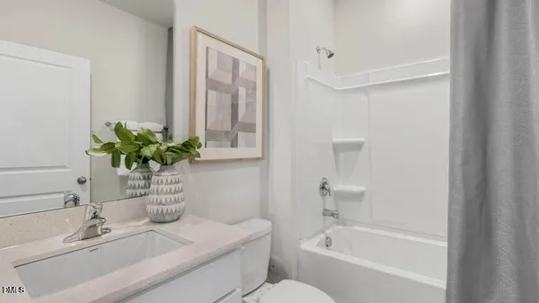 a white bath tub sitting next to a white sink