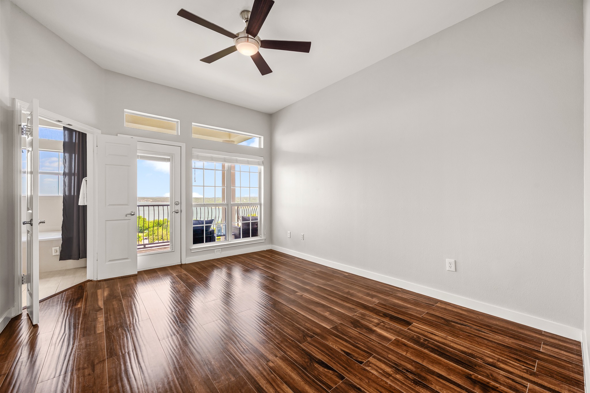 2918 Ranch Road 620 North, Unit S242 Austin, TX 78734 - Photo 21 of 35 Rich hardwood flooring leads to a private balcony, perfect for serene mornings or evening relaxation.