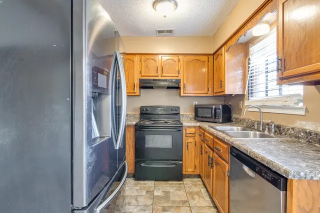 a kitchen with a sink stove and cabinets