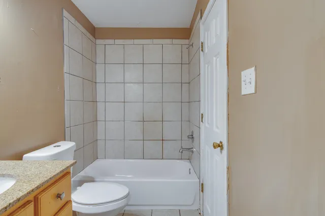 a bathroom with a bathtub and toilet