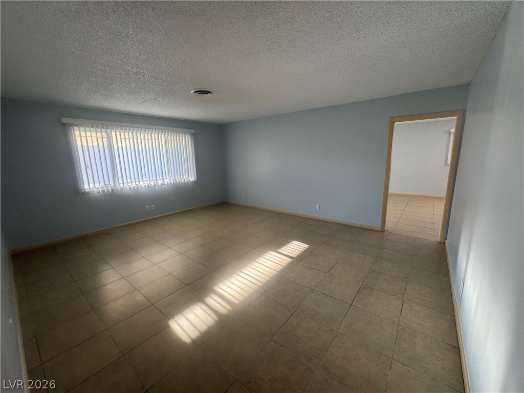 4420 Del Monte Avenue, Unit RENTAL Las Vegas, NV 89102 - Photo 11 of 20 A window-filled living area featuring tiled flooring for effortless upkeep.