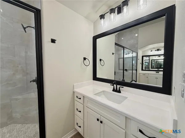 a bathroom with a sink and a mirror