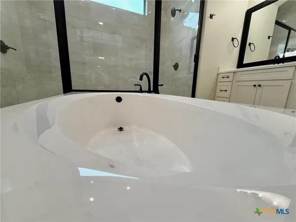 a bathroom with a bathtub and a sink