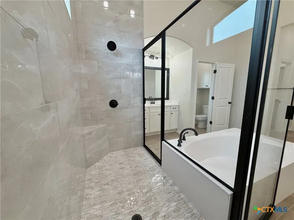 a bathroom with a tub and a shower