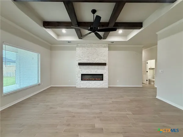 a view of an empty room with a fireplace