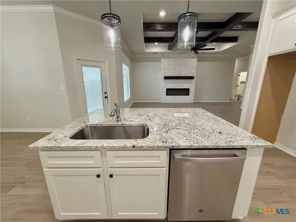 a kitchen with stainless steel appliances granite countertop a sink and a refrigerator