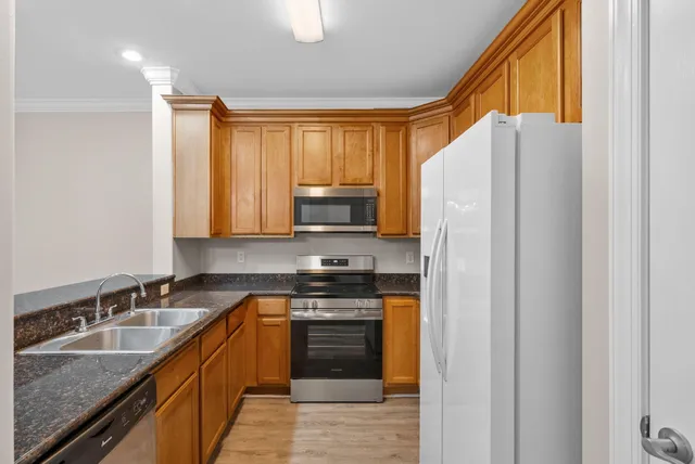 a kitchen with a refrigerator a sink and a stove
