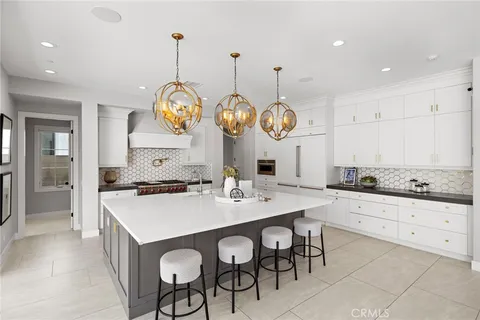 a kitchen with a dining table and chairs