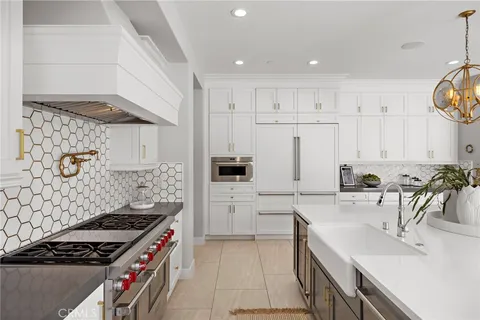 a kitchen with granite countertop a sink stove and cabinets