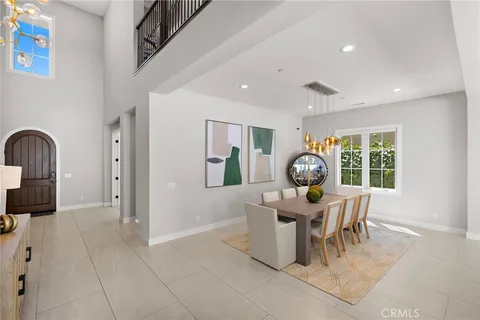 a living room with furniture a table and large windows
