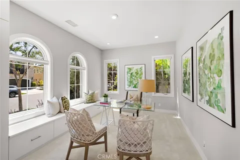 a living room with furniture and large windows