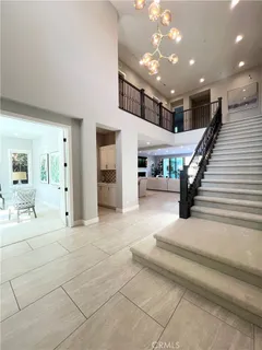 a spacious bedroom with a bed and large windows