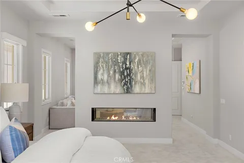 a living room with furniture kitchen view and a flat screen tv