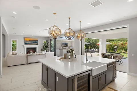 a kitchen with counter top space and living room view