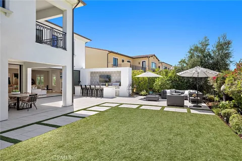 a view of a house with backyard porch and sitting area