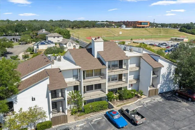 a view of a wooden house with a yard