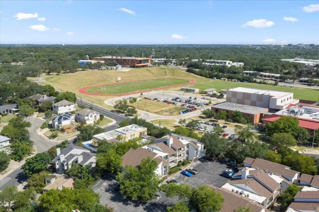 an aerial view of house with outdoor space and lake view