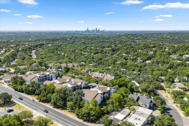 an aerial view of residential houses with outdoor space and river