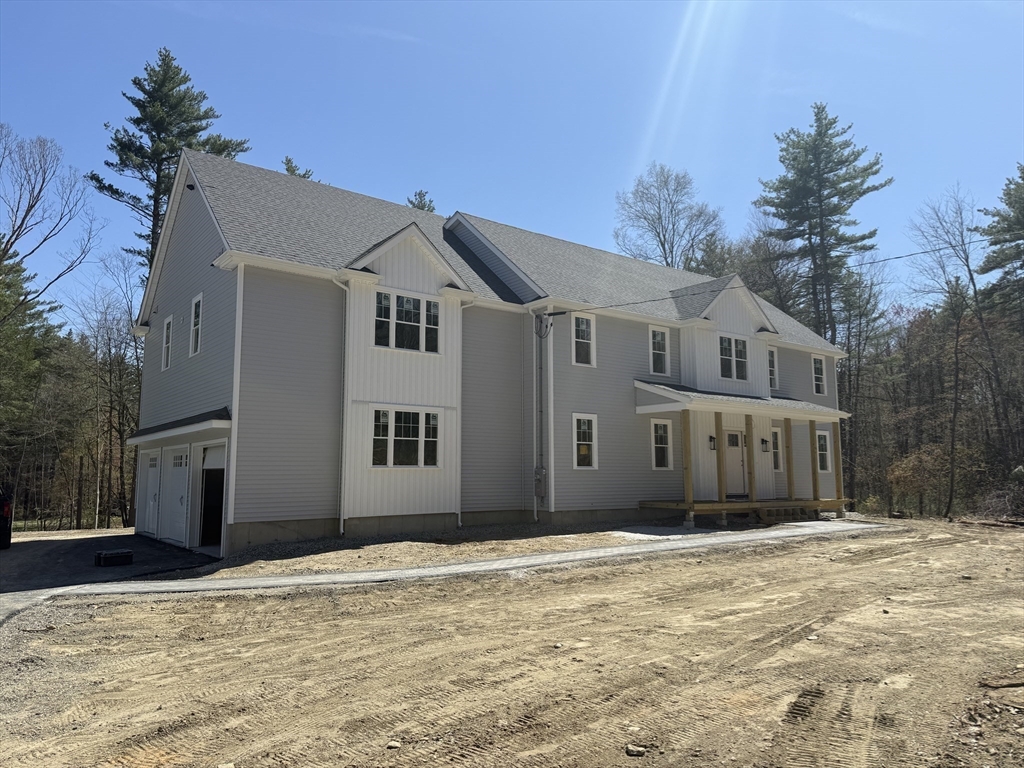 120 Maple Street Stow, MA 01775 - Photo 7 of 36 a front view of a house with a yard