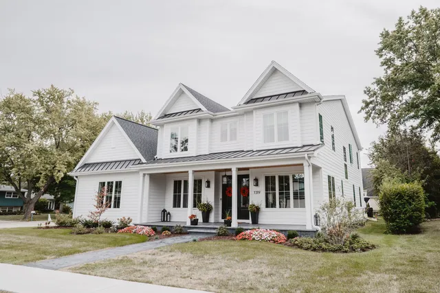 a front view of a house with a yard and seating space