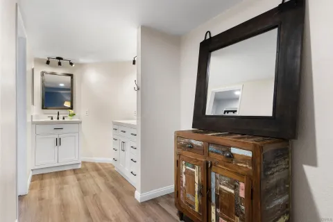 a bathroom with a sink vanity and mirror