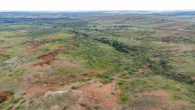 a view of a field with an ocean view