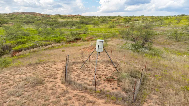 a view of a field with an ocean view