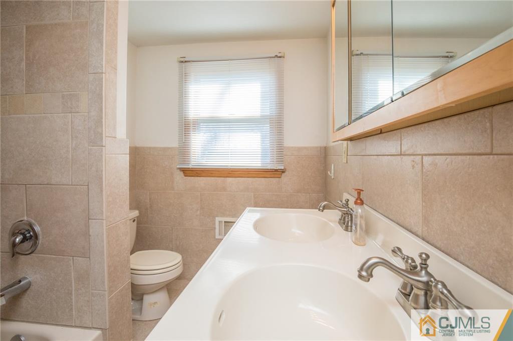 48 Caldwell Road Edison, NJ 08817 - Photo 13 of 24 a bathroom with a sink and a toilet