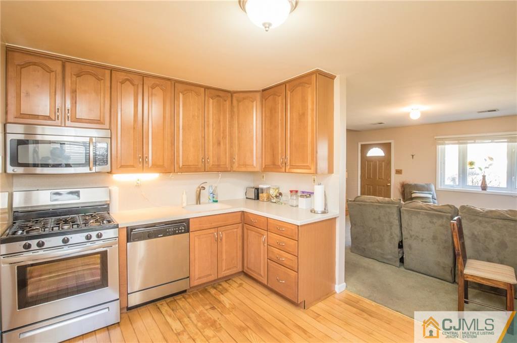 48 Caldwell Road Edison, NJ 08817 - Photo 14 of 24 a kitchen with a stove a sink and a refrigerator